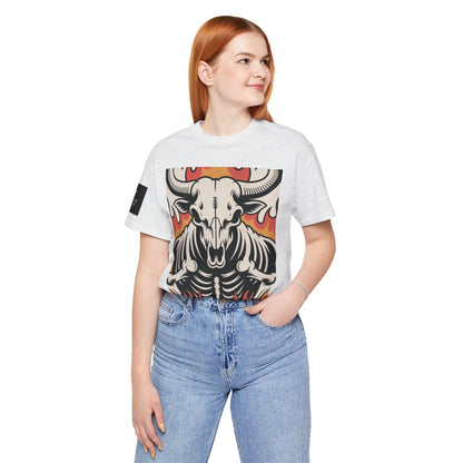 Mujer usando una camiseta ceniza de manga corta con un diseño gráfico central de una calavera de toro con cuernos, estilo ilustración, sobre un fondo de llamas en tonos rojo, naranja y negro.