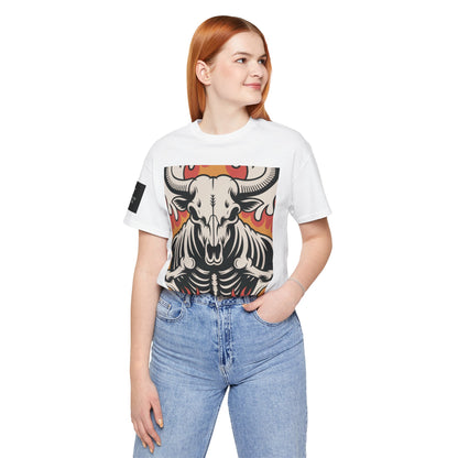 Mujer usando una camiseta blanca de manga corta con un diseño gráfico central de una calavera de toro con cuernos, estilo ilustración, sobre un fondo de llamas en tonos rojo, naranja y negro.